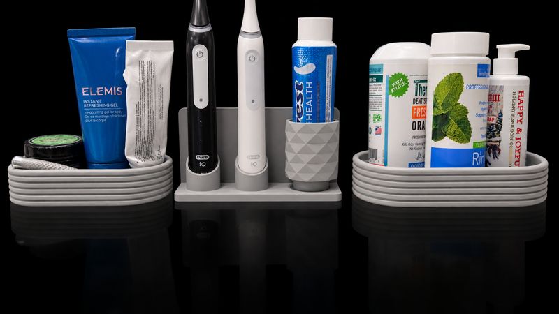 Custom 3D printed bathroom organizer holding toothbrushes, toothpaste and toiletries