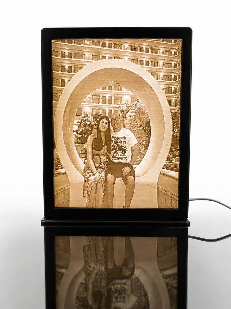 Backlit 3D printed lithophane of a couple, mounted in a black frame