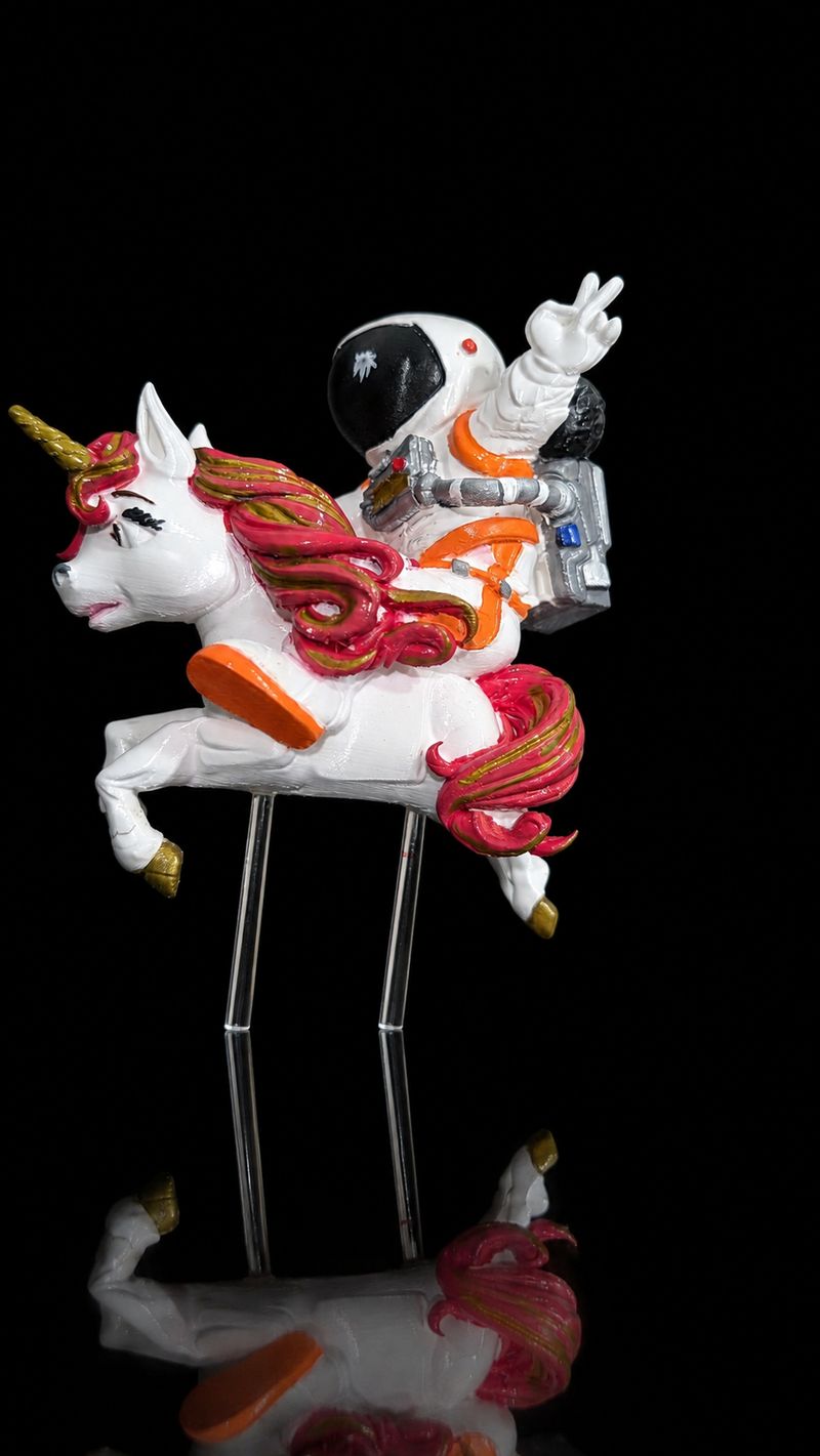 The same cake topper after hand painting in pink, orange and white